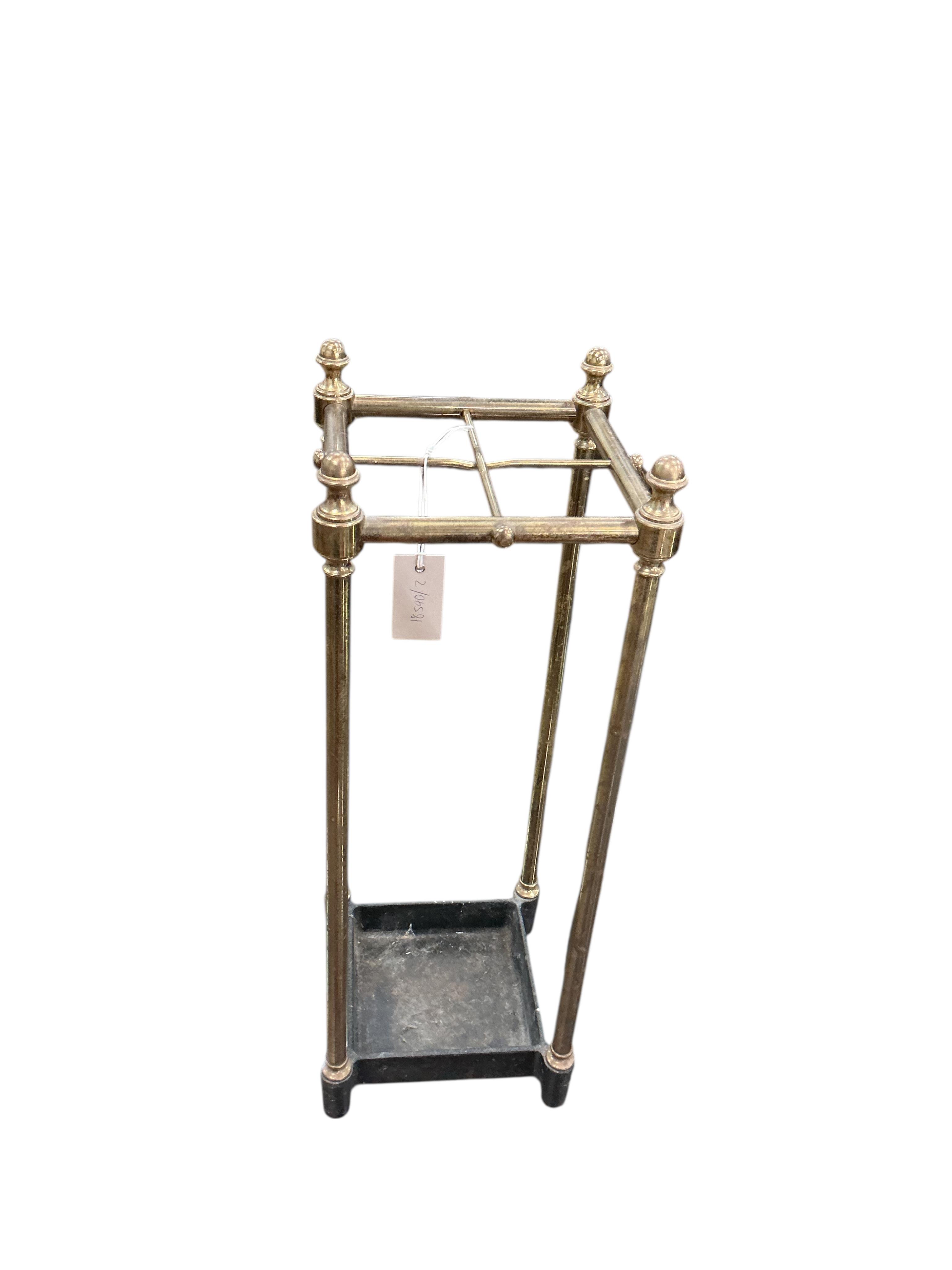 A brass and cast iron four division stick stand, width 21cm, height 59cm